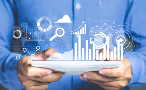 business man holding ipad with analytics icons